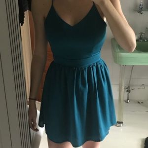 Elegant teal skater dress with open back